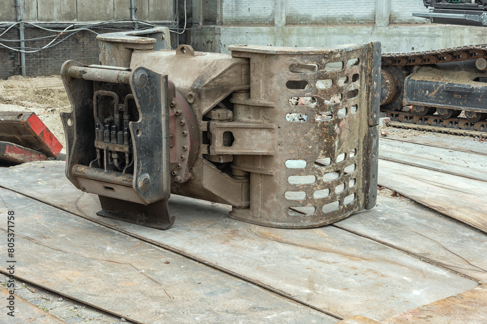 steel hydraulic bucket of an excavator lies outside on the ground