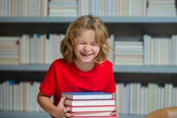 Aufkleber - Elementary schoolboy. Schoolboy reading book in library. Kids development, learn to read. Pupil reading books in a school library. School child doing homework, study hard.