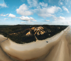 Wall Mural - aerial drone view of the pinnacles, colored sands on fraser island, sunrise with car. kgari, queensl