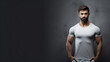 Young bodybuilder man posing on a grey background with negative space text. Gym, workout, exercise, healthy lifestyle, wellness, male, weightlifting.