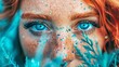   A tight shot of a woman's face, her blue eyes bright and freckles scattering like light snowflakes