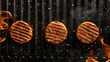   Three hamburgers sizzle on a flamed grill; flames dance above and below