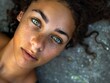 Stunning high resolution photo of a reclining girl with unique eyes and caramel skin looking forward
