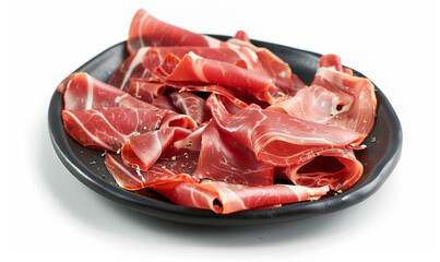 Wall Mural - delicious jamon on black plato on a white background close-up
