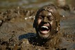 © Ева Поликарпова - A man covered in mud, laughing joyfully. Suitable for outdoor activities promotion