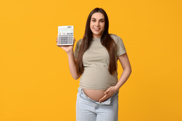 Wall Mural - Pregnant young woman with calculator on yellow background