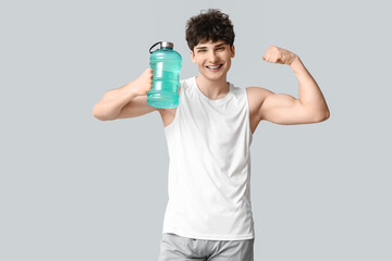 Sticker - Sporty guy with bottle of water showing muscle on white background