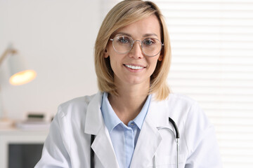 Wall Mural - Portrait of smiling doctor on blurred background