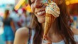 The woman is happily enjoying her ice cream cone with sprinkles on her face at a public event. She smiles with joy, as she indulges in the sweet treat during this fun leisure activity AIG50