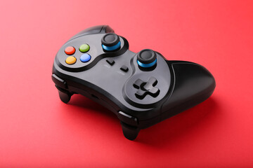 Wall Mural - One wireless game controller on red background