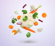 Different fresh vegetables in air on light background