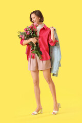 Poster - Young woman with pink roses on yellow background