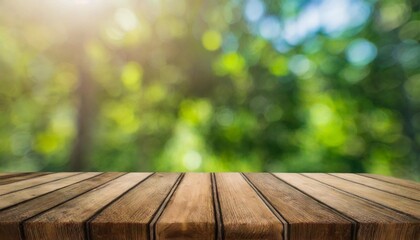 Wall Mural - empty wooden table top with blur garden background with bokeh for product display stage podium