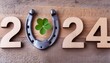 horseshoe with lucky clover 2024 greeting card horseshoe on wooden background happy new year greetings wishes