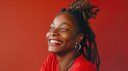 Poster - A woman with dreadlocks is smiling and wearing a red shirt