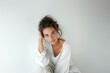 © Studium L&M - Young Italian woman in white shirt, casual pose, neutral background, intimate and natural look.