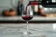 A glass of red wine is poured into wine glass