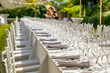 Served wedding table with plates, white chairs, napkins and wine glasses