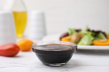 Vinegar in bowl on light textured table, closeup