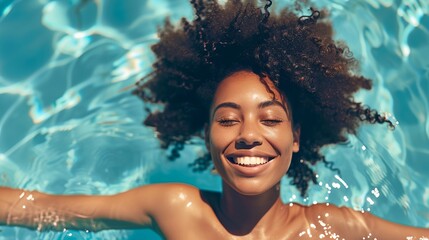 Wall Mural - a woman with a smile on her face swimming in a pool