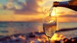 © Artyom - Sparkling wine being poured into glass at sunset by sea