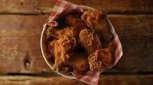 A Top-down View Of A Paper Bucket Filled With Delicious Fried Chicken, The Aroma Wafting Through The Air