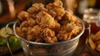 Close-up of a bucket filled with a variety of crispy fried chicken pieces, each one seasoned to perfection