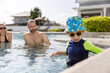 © eakgrungenerd - Happy vacation kid boy with family parent have fun enjoy at swimming pool. father and mother with son cheerful activity relaxing in summer holiday.