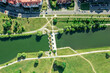 aerial view of city residential area near the river with small dam in sunny summer day.