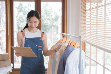 Poster - Woman checking her merchandise in cloth shop