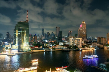 Wall Mural - Bangkok cityscape. Bangkok night view in the business district at twilight with Chaophraya river pier