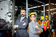 © Stella - Portrait of senior businessman manager with beautiful woman industrial engineer worker with helmet and safety glasses holding laptop computer at manufacturing industry factory. People at workplace.