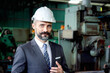 © Stella - Portrait of senior businessman boss with safety helmet inspects manufacturing plant industry factory. Manager inspects workplace, checking production process. Industry maintenance manager at work site