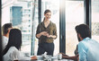 © peopleimages.com - Woman, leader and business meeting at company with collaboration, ideas or communication with employees. Female manager, teamwork and office with table for brainstorming, review of global sales