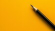   A black pen atop a yellow table Nearby, a black eraser rests on the table's surface