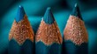  A tight shot of three pencils with blue and orange crayon tips