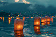 Paper lanterns float on dark water, traditional floating lantern festival, memorial day, serene and cultural atmosphere.