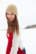 Woman, portrait and fashion in outdoor snow, warm clothes and designer jersey or season outfit. Female person, smile and cold weather on holiday or vacation, style and beanie aesthetic in Switzerland