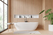 Modern bathroom interior with a white bathtub, wooden walls, and tropical plant, in light daylight, concept of relaxation. 3D Rendering