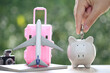 Piggy bank and airplane on passport with natural green background,Saving planning for Travel budget of holiday concept