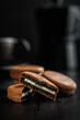 Close-Up View of Chocolate-Coated Sandwich Cookies on Dark Background