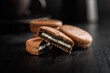 Close-Up View of Chocolate-Coated Sandwich Cookies on Dark Background