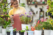 Gardener Asia woman care  plant flower in garden. People hobby and freelance gardening indoor at home, nature garden background. Happy and enjoy in springtime and summer day.Â  Lifestyle Concept