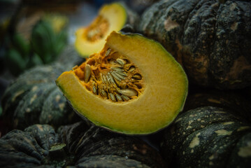 Wall Mural - Pumpkins cut into halves are sold at the local fresh market in Ban Na Kluea, Thailand.