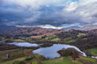 Stunning aerial drone landscape image over River Brathay near Elterwater in Lake District with Langdale Pikes in distance
