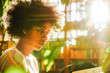© VisualProduction - A focused young Afro-American student studying in a sunlit library, their concentration heightened by the bright, natural illumination.