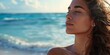 © Chimpanzky  - profile of a beautiful woman standing on the beach with her eyes closed, peaceful relaxation and blissfulness