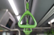A green handle is hanging from a metal bar
