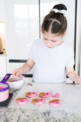 Canvas Print - Young Chef Prepares Chocolate-Covered Treats in Sunny Kitchen