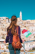 Tourist woman with italian flag looking at Matera town in Italy